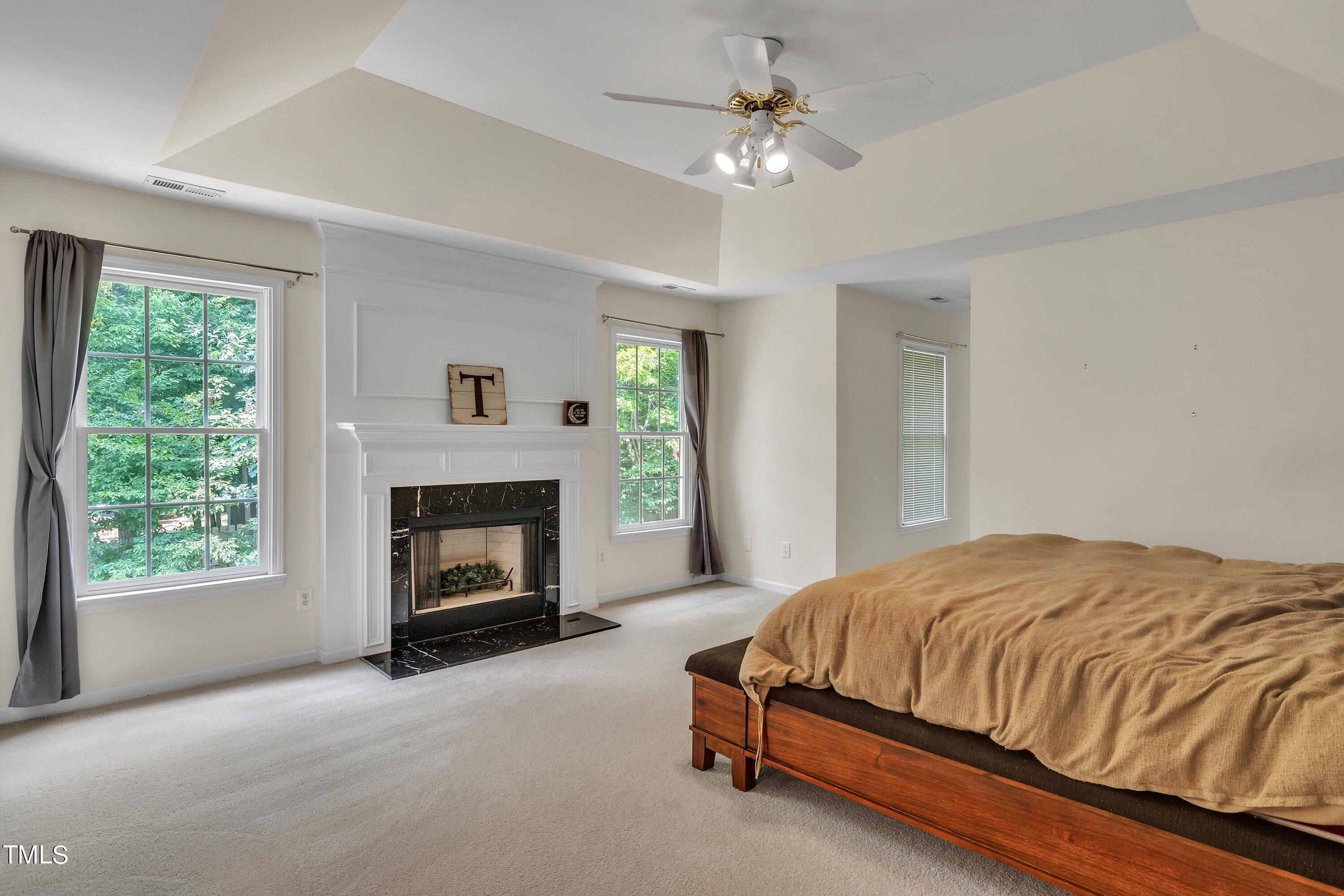 4702 Regency Drive Durham, NC 27713 - Photo 25 of 45 a bedroom with a bed and a fireplace