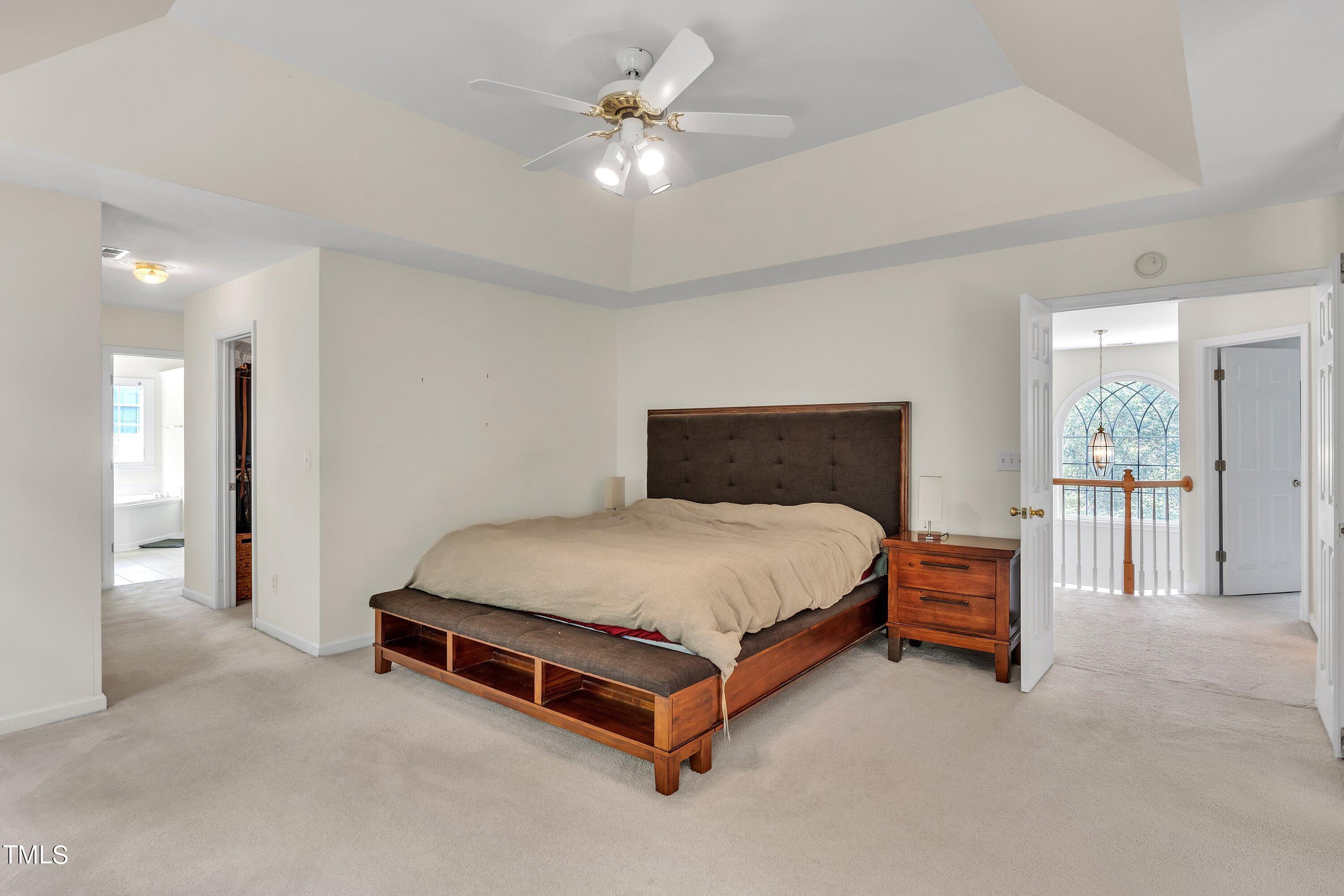 4702 Regency Drive Durham, NC 27713 - Photo 26 of 45 a bedroom with a bed and a ceiling fan