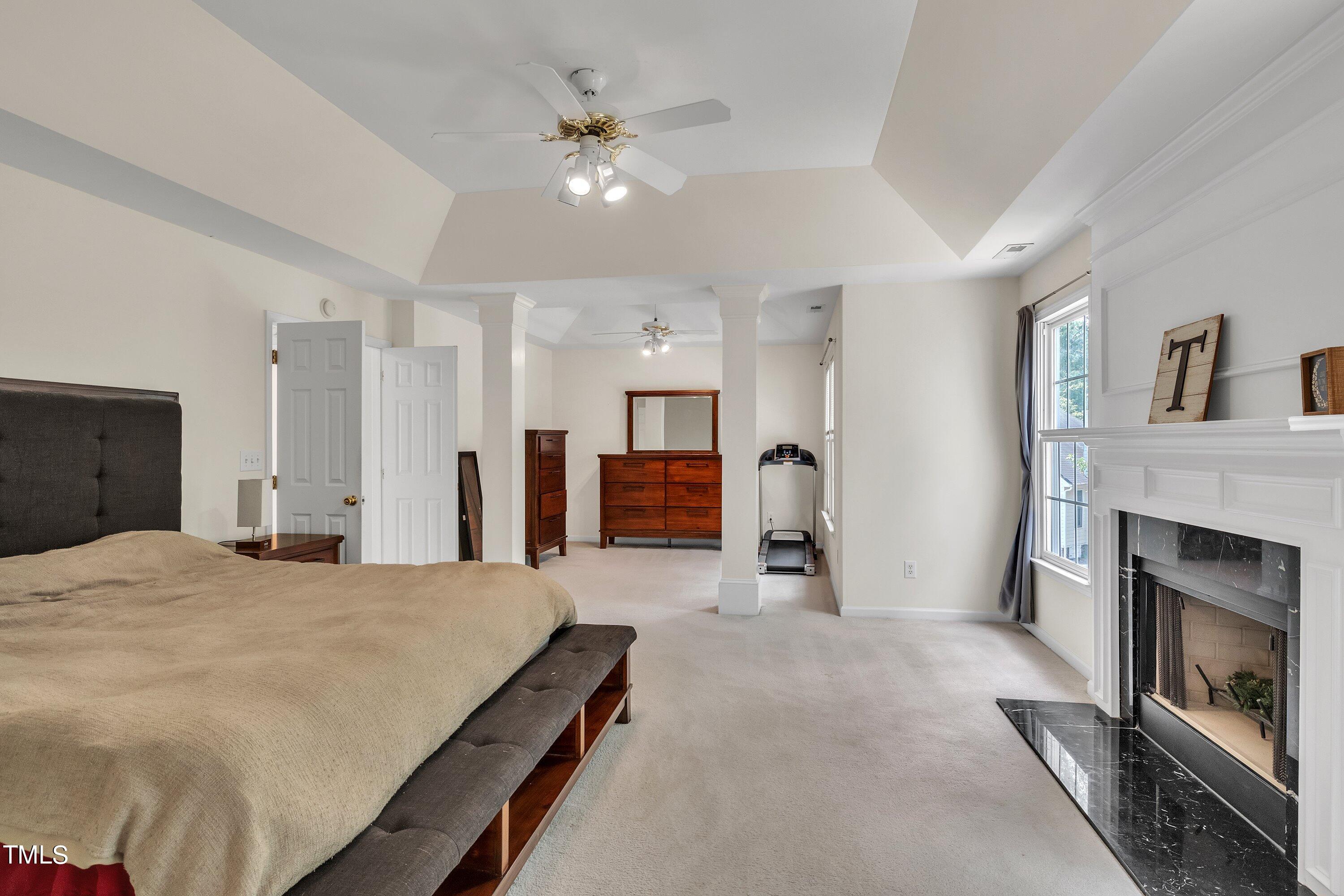 4702 Regency Drive Durham, NC 27713 - Photo 27 of 45 a spacious bedroom with a bed and a fireplace