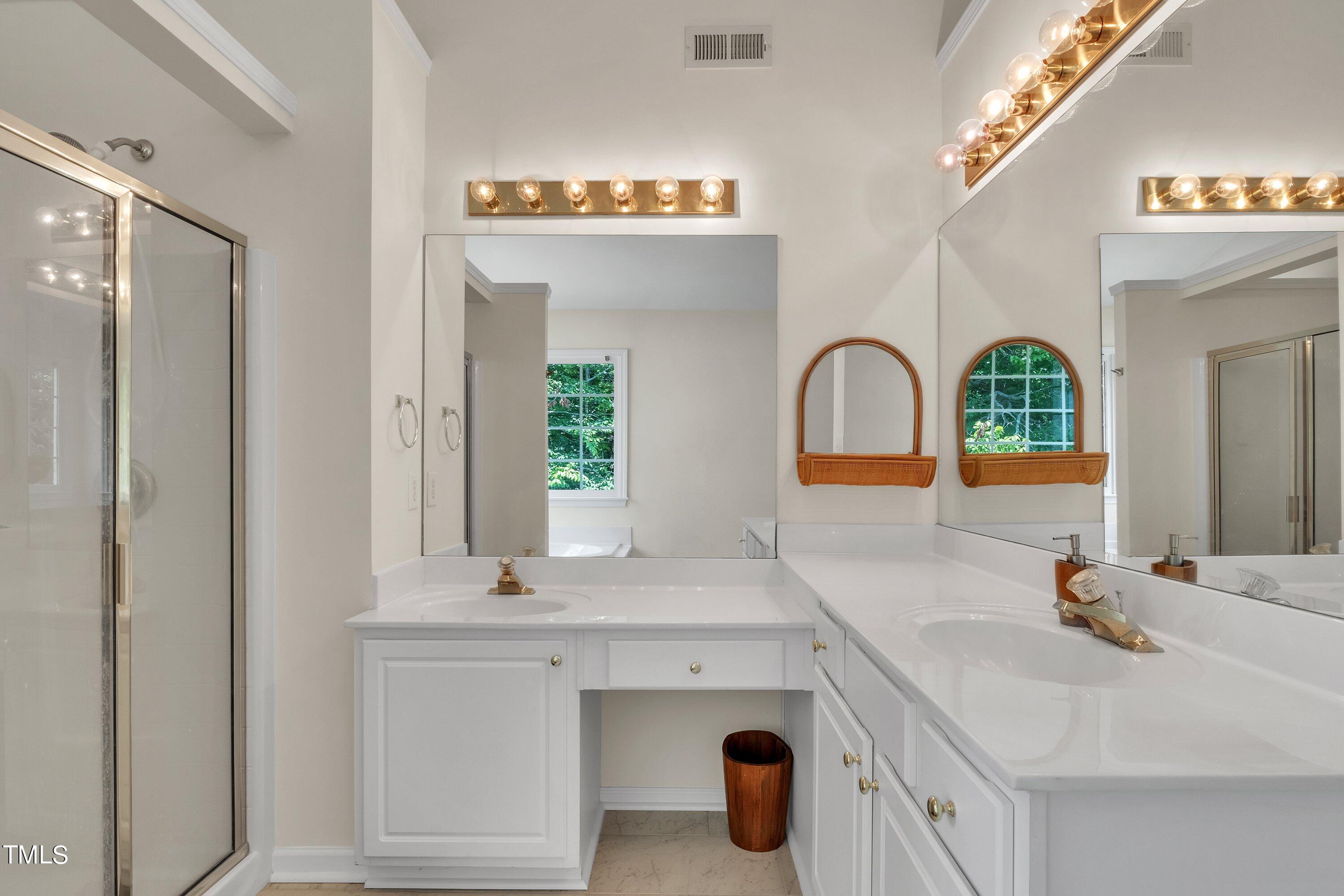 4702 Regency Drive Durham, NC 27713 - Photo 30 of 45 a bathroom with a sink and a mirror