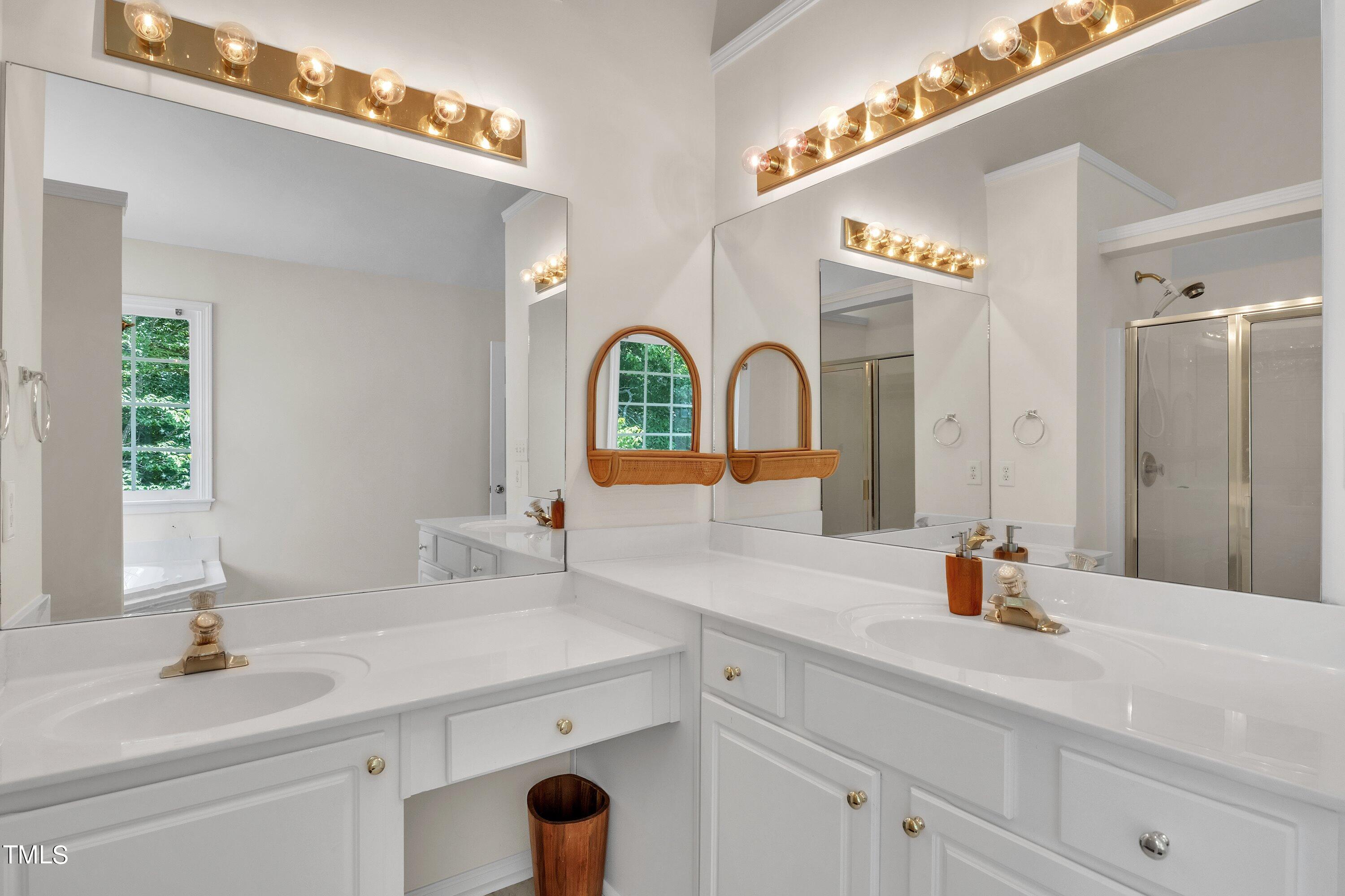 4702 Regency Drive Durham, NC 27713 - Photo 31 of 45 a bathroom with a double vanity sink and a mirror