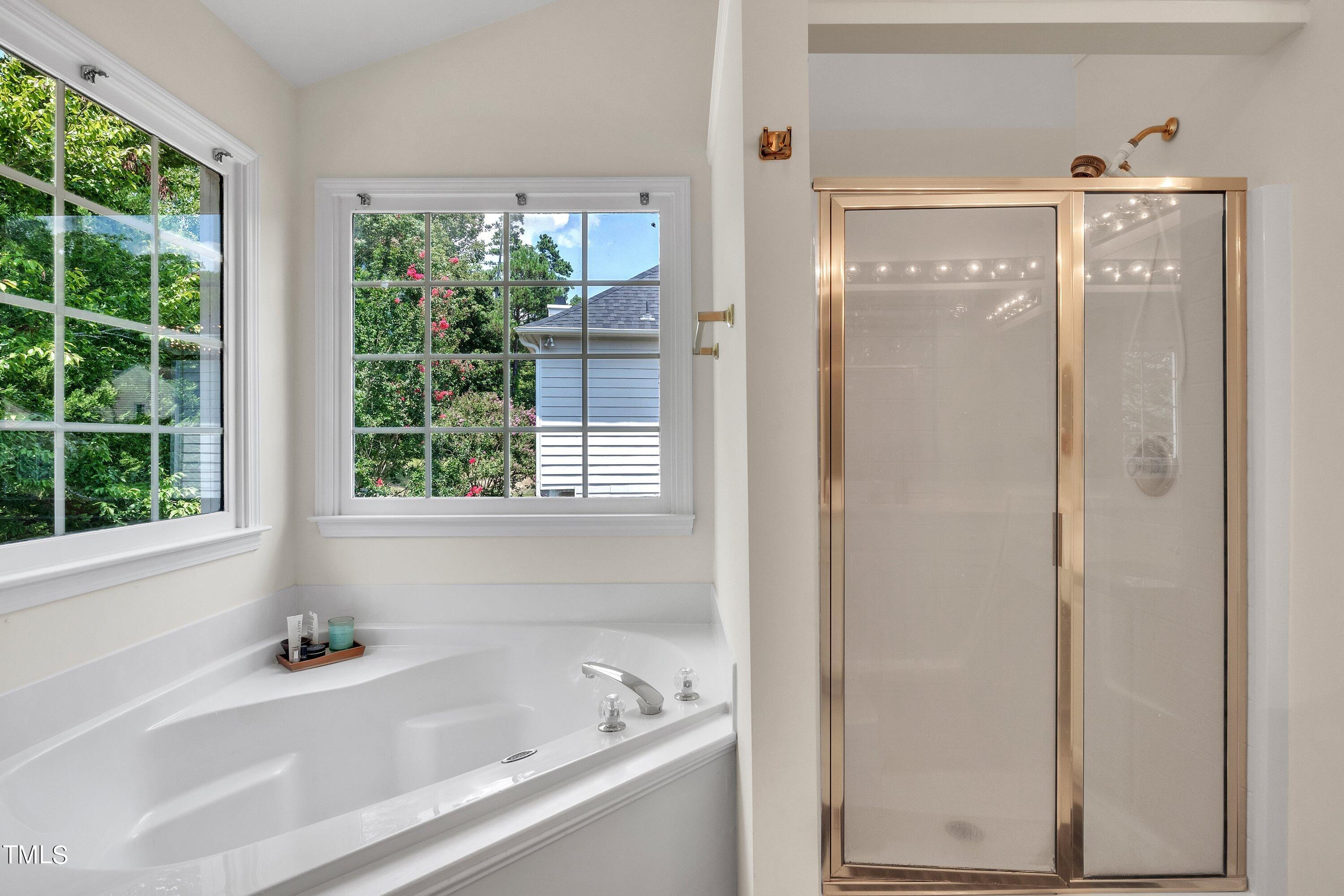 4702 Regency Drive Durham, NC 27713 - Photo 32 of 45 a bathroom with a bathtub and a shower