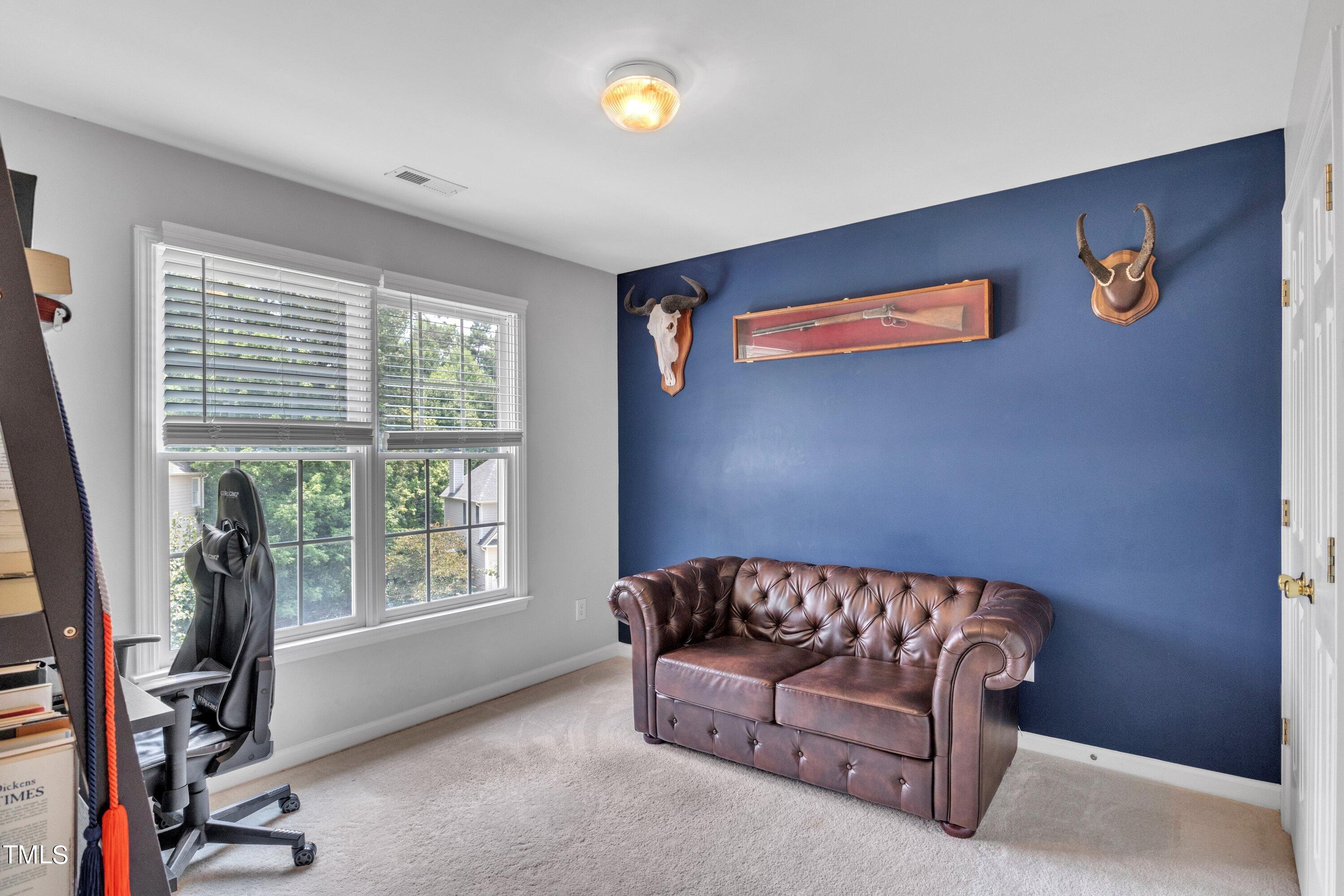 4702 Regency Drive Durham, NC 27713 - Photo 33 of 45 a living room with furniture and a flat screen tv