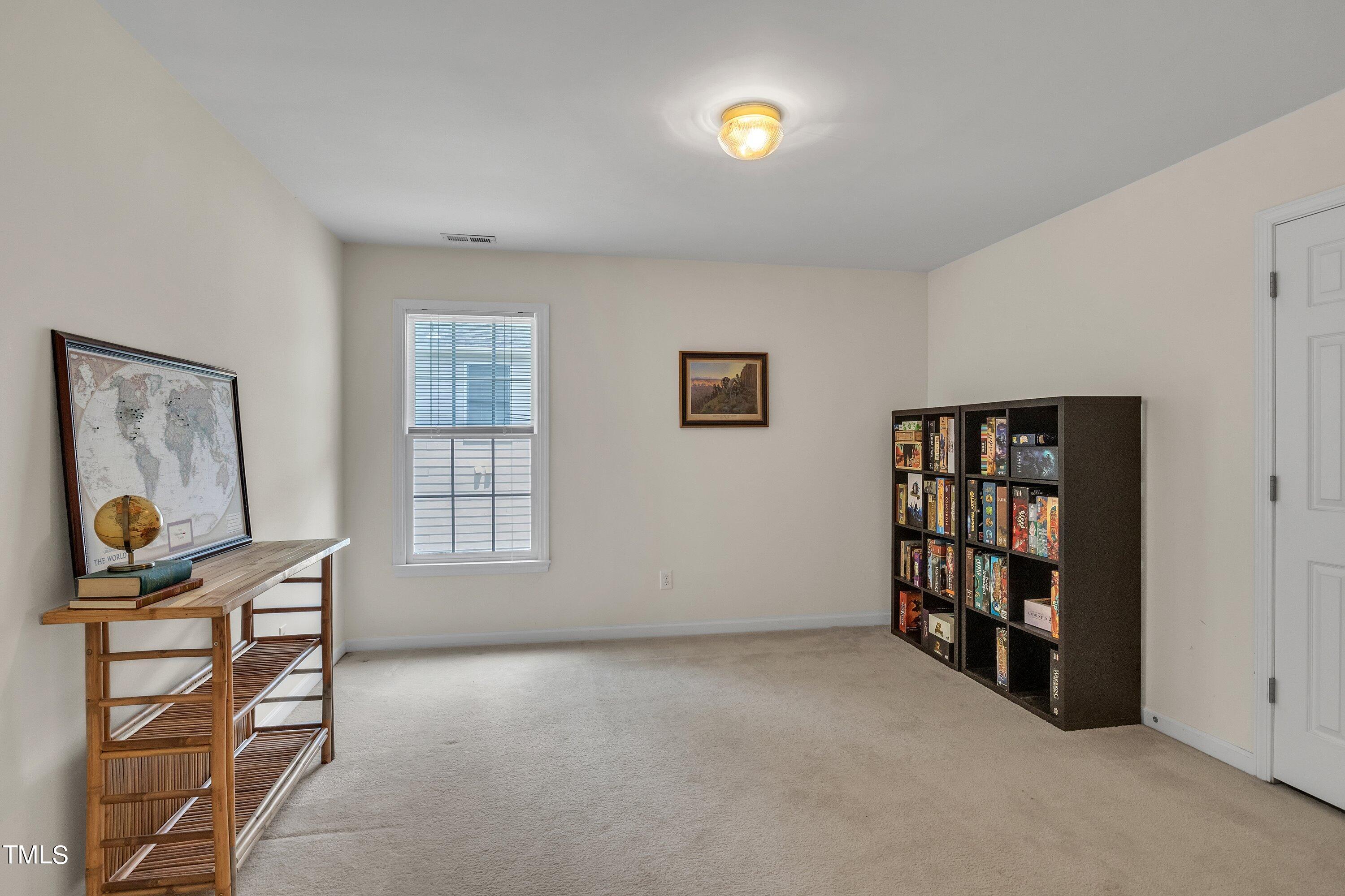 4702 Regency Drive Durham, NC 27713 - Photo 35 of 45 a view of room with lounge chair and cabinet