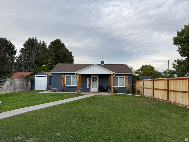 433 East 200 South Payson, UT 84651 - Photo 2 of 21 Blue exterior with white trim, covered front entry, two wood-finish columns, and a front lawn