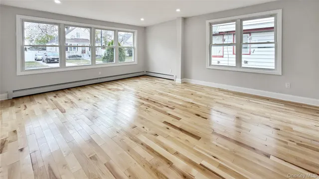 a view of a room with wooden floor and natural light
