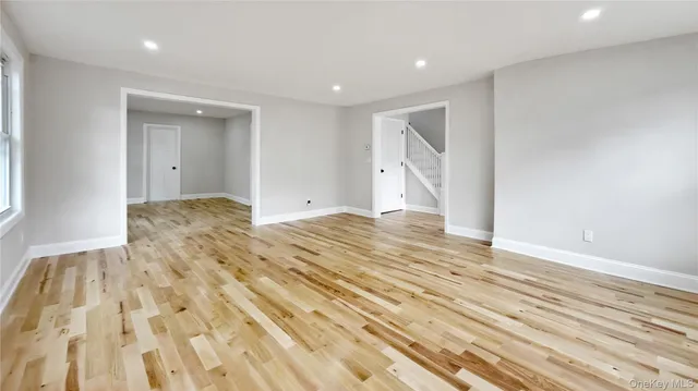 a view of a room with wooden floor and natural light