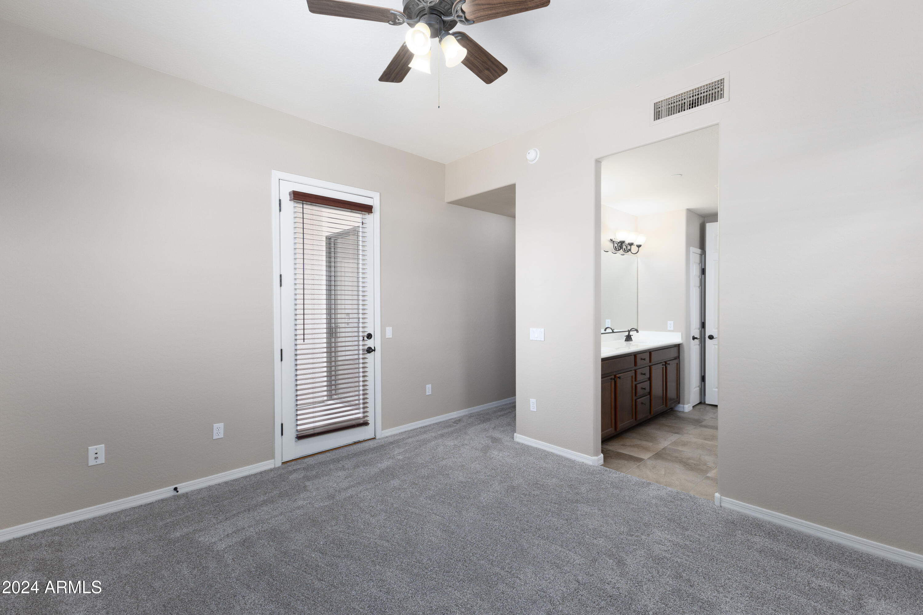 3330 South Gilbert Road, Unit 2010 Chandler, AZ 85286 - Photo 11 of 20 an empty room with a ceiling fan and a bathroom
