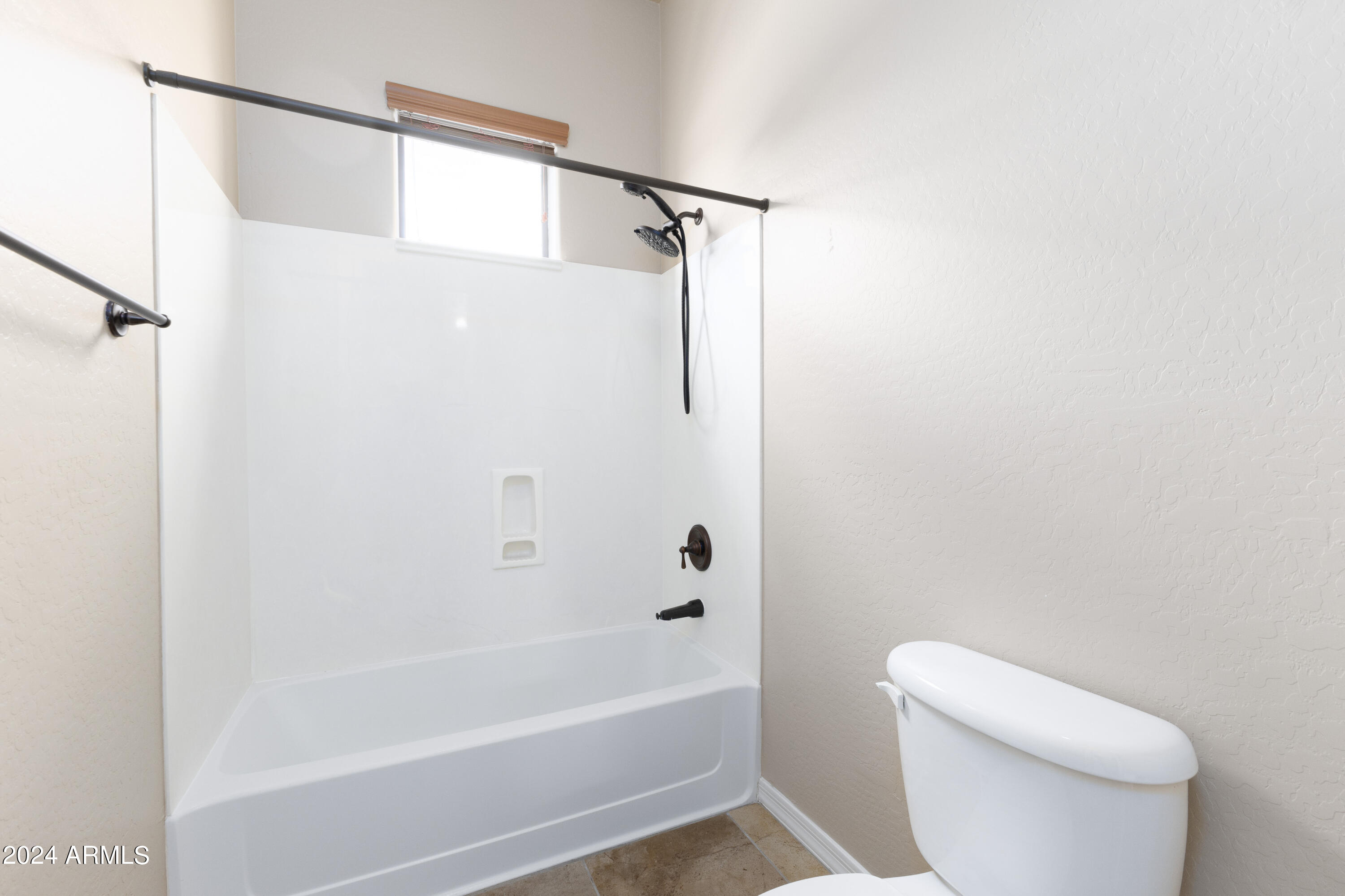 3330 South Gilbert Road, Unit 2010 Chandler, AZ 85286 - Photo 14 of 20 a bathroom with a shower a toilet and a bathtub