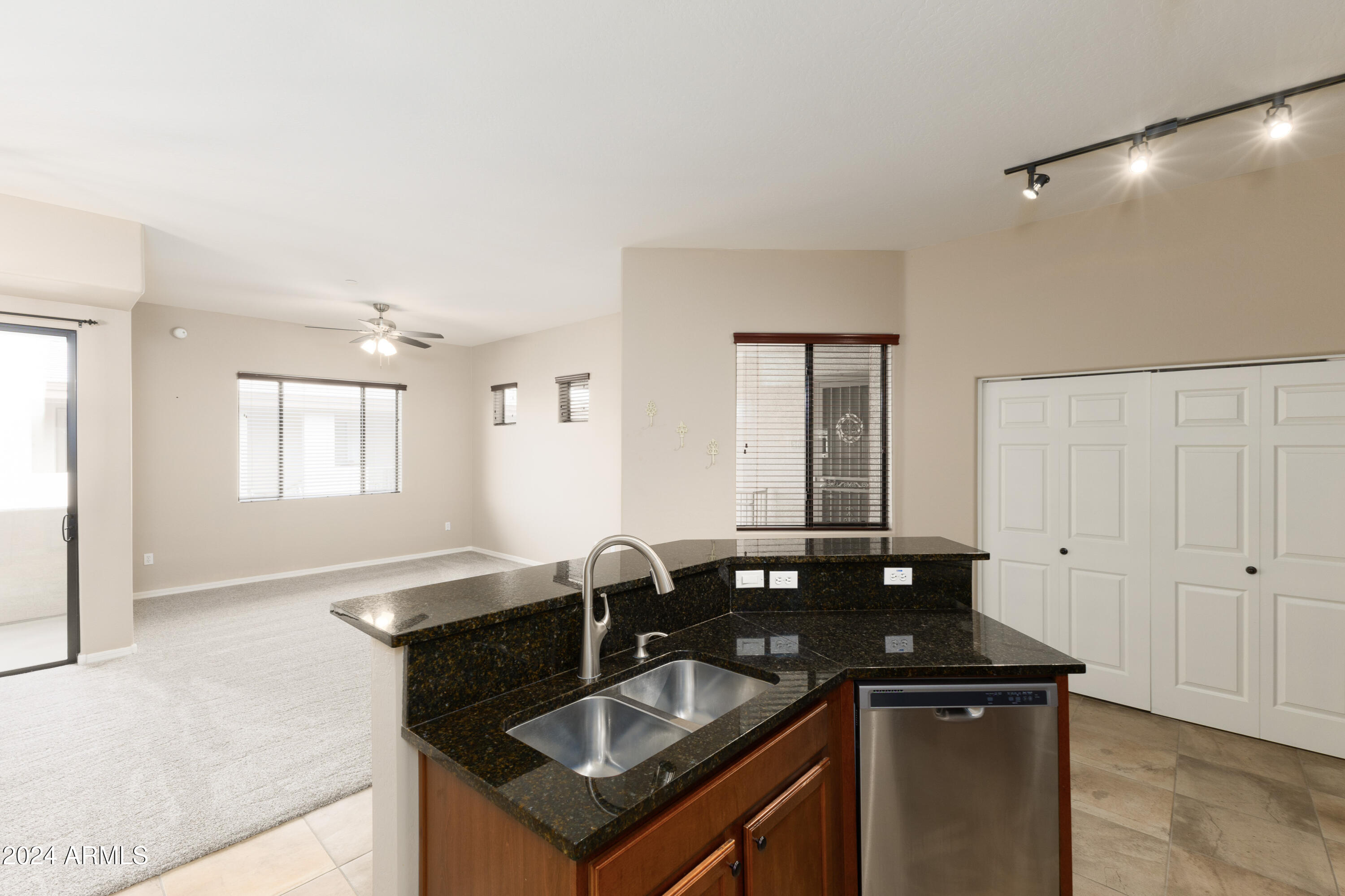 3330 South Gilbert Road, Unit 2010 Chandler, AZ 85286 - Photo 7 of 20 a kitchen with granite countertop a sink and cabinets