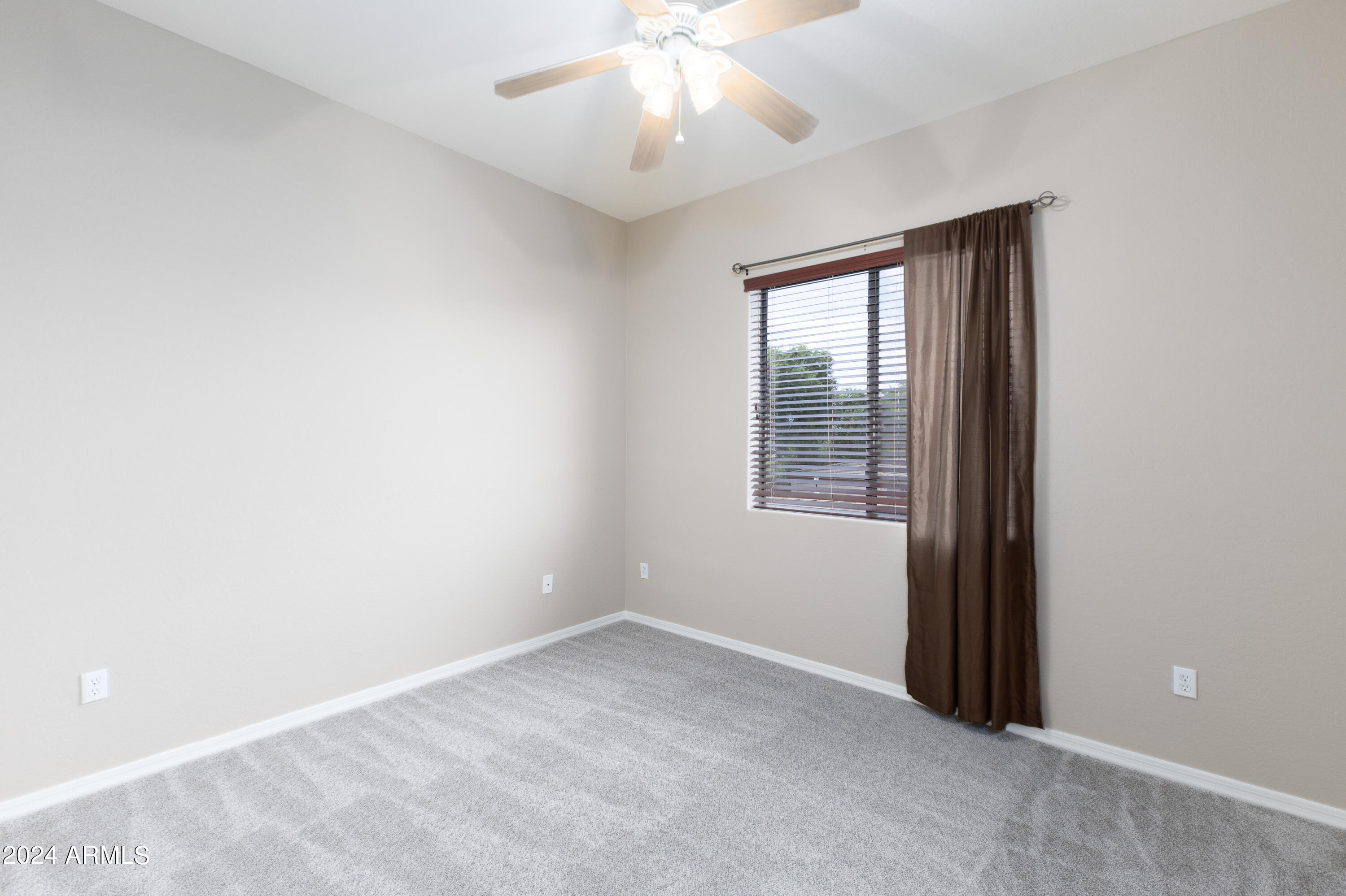 3330 South Gilbert Road, Unit 2010 Chandler, AZ 85286 - Photo 10 of 20 an empty room with windows and fan