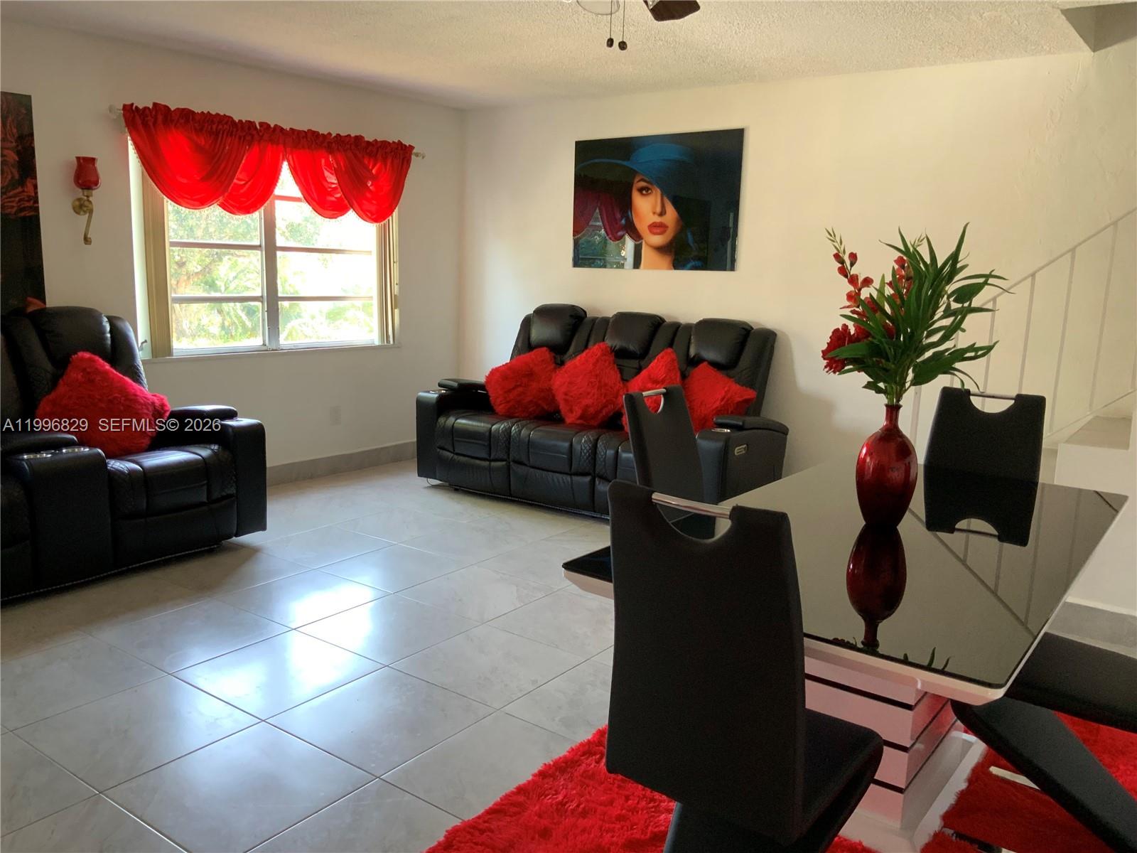 1300 West 53rd Street, Unit 35 Hialeah, FL 33012 - Photo 9 of 9 a living room with furniture and a flat screen tv