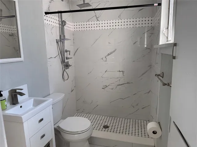 a bathroom with a sink toilet and shower