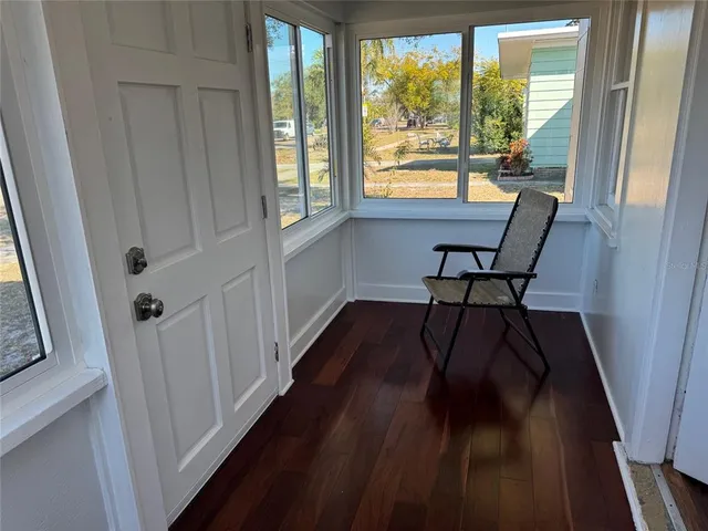 a view of a room with wooden floor and furniture