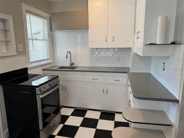 a kitchen with a stove a sink and a refrigerator