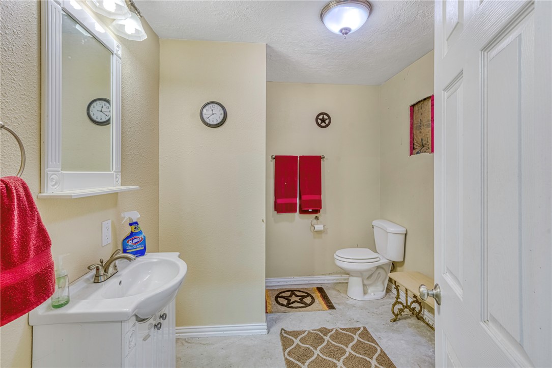 9945 Oxford Cemetery Road Madisonville, TX 77864 - Photo 38 of 42 Half bath with a textured ceiling and vanity