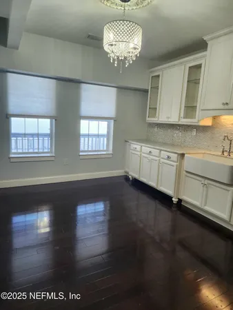a large kitchen with granite countertop a stove and a sink