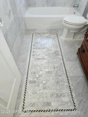 a bathroom with a sink toilet vanity and shower