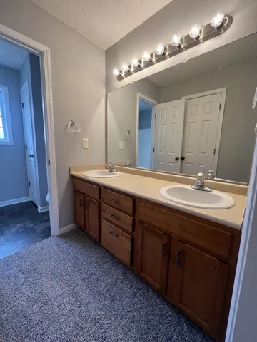 a bathroom with a double vanity sink and a mirror