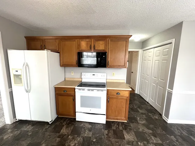 a kitchen with a refrigerator sink and stove