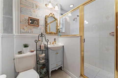 a bathroom with a sink toilet and shower