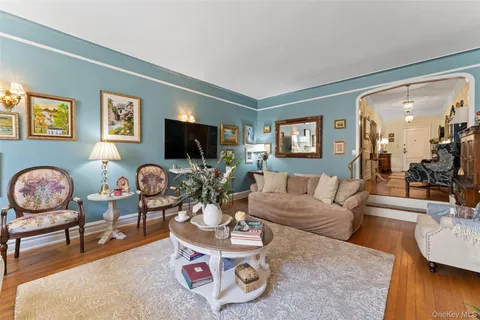 a living room with furniture a wooden floor and a flat screen tv