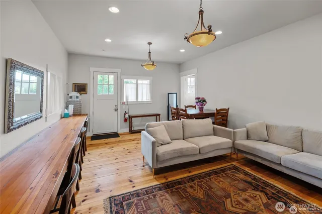 a living room with furniture and a chandelier