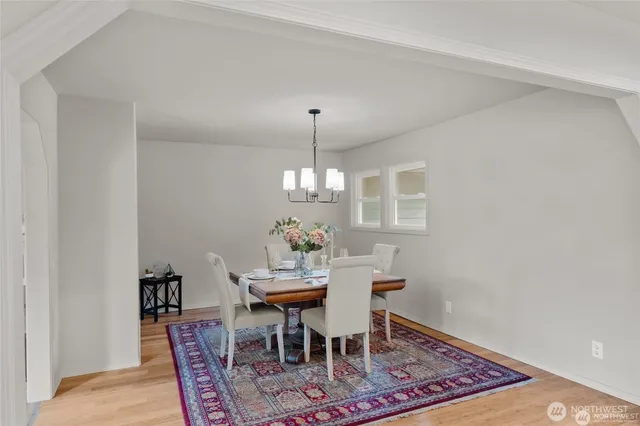 a dining room with furniture a rug and a chandelier