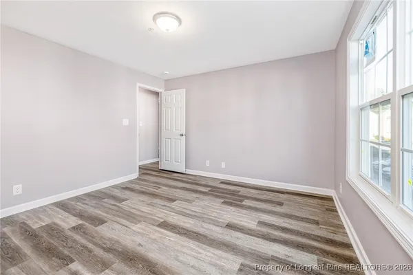 a view of room with window and hardwood floor