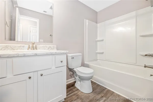 a bathroom with a sink toilet a mirror and shower