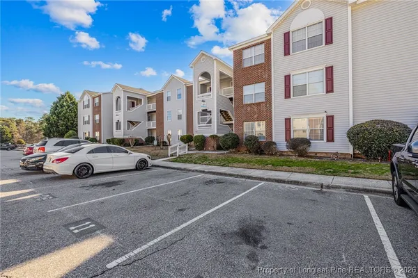 a view of a cars park in front of a building