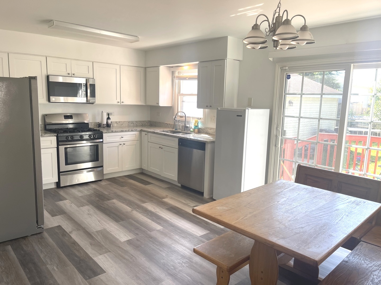 2411 Leckrone Drive Plainfield, IL 60586 - Photo 2 of 11 a kitchen with stainless steel appliances granite countertop a stove top oven a refrigerator a sink dishwasher with a dining table and chairs