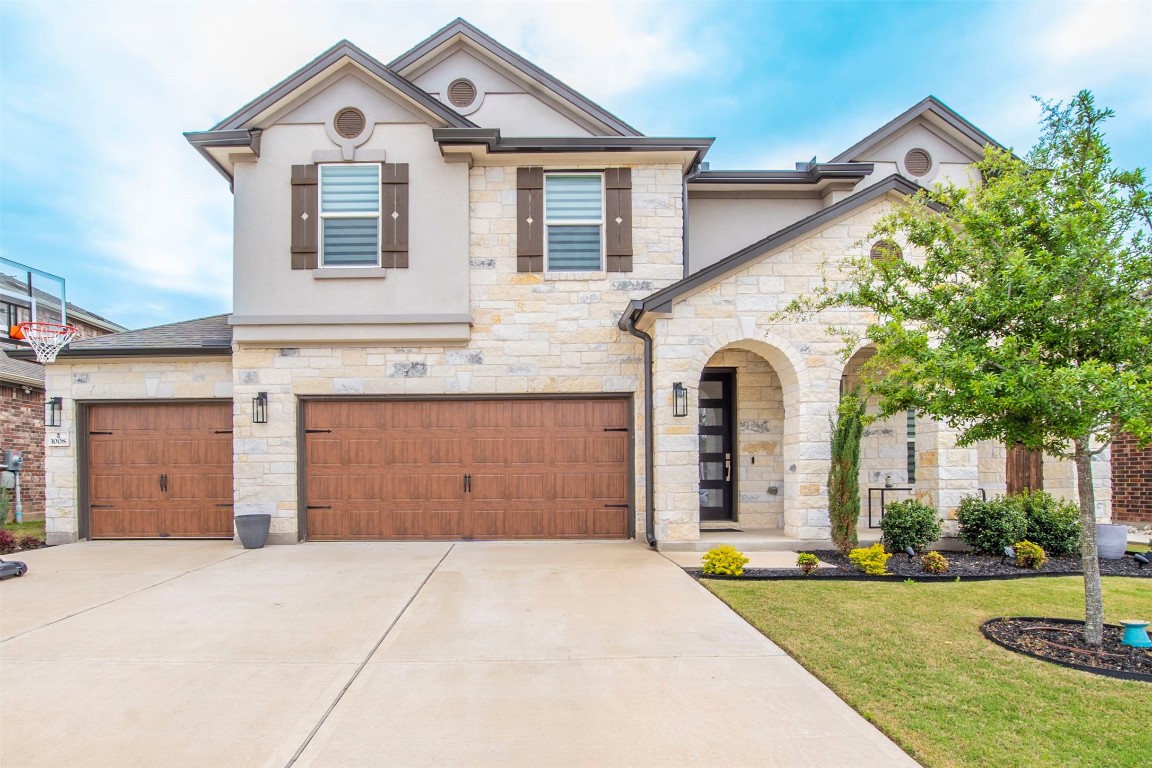 a front view of a house with a yard and garage