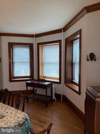 a living room with furniture and two windows