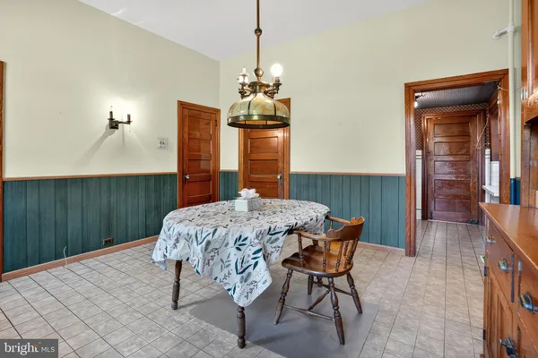 a dining room with a table and chairs