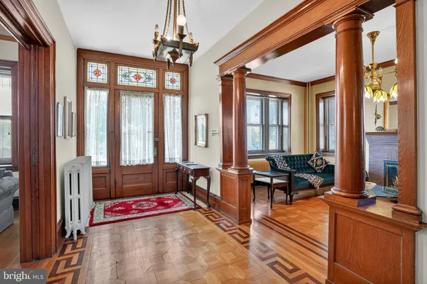 a living room with furniture and a chandelier