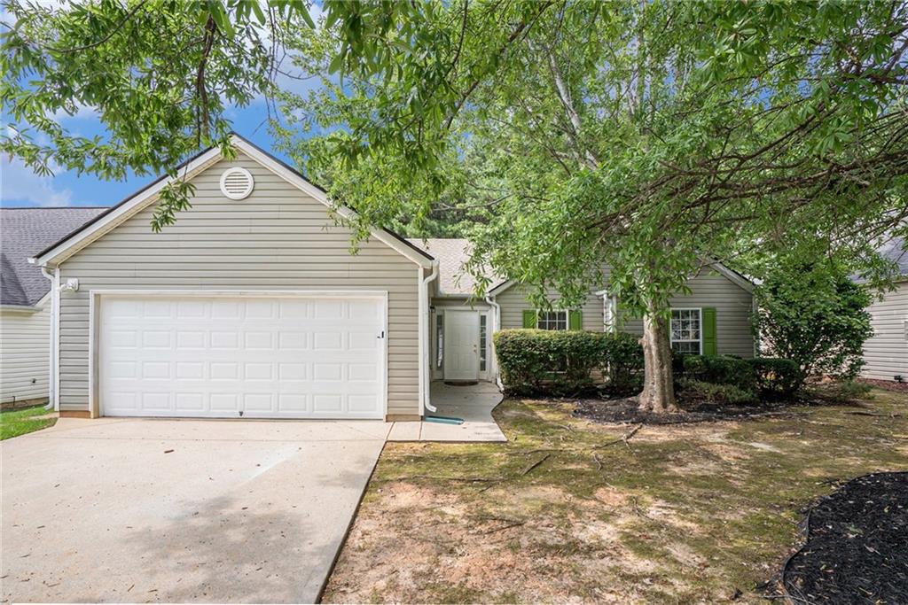 a view of a house with a yard and garage
