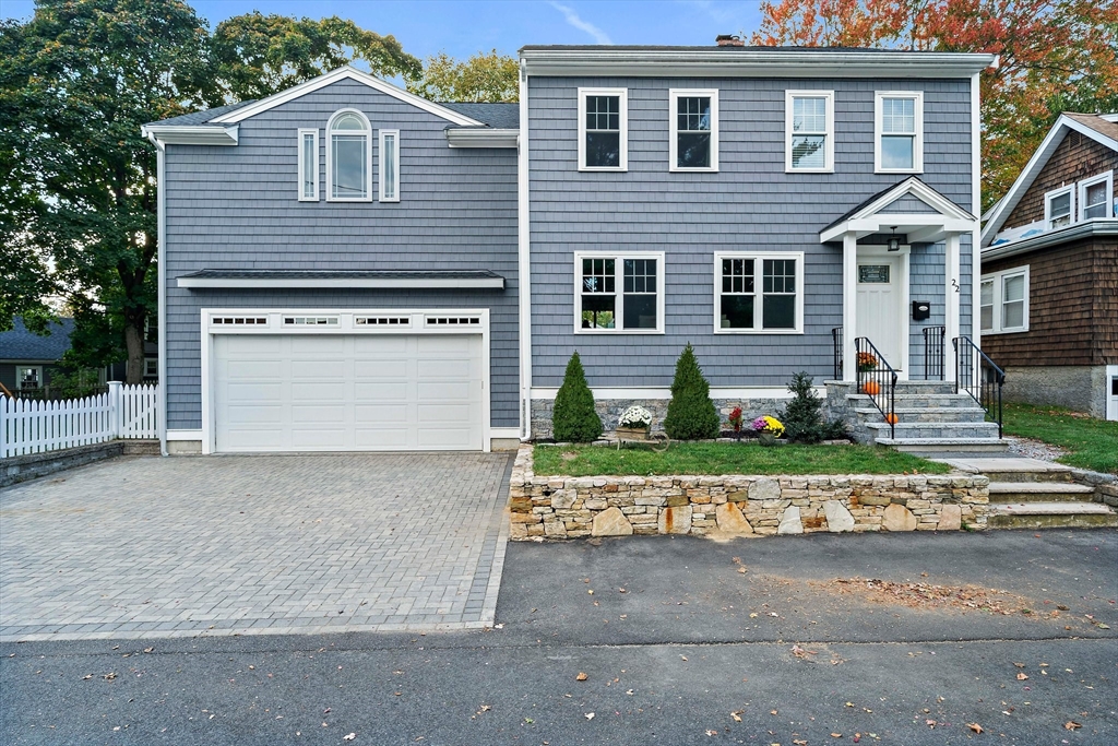 a front view of a house with a yard and a garage