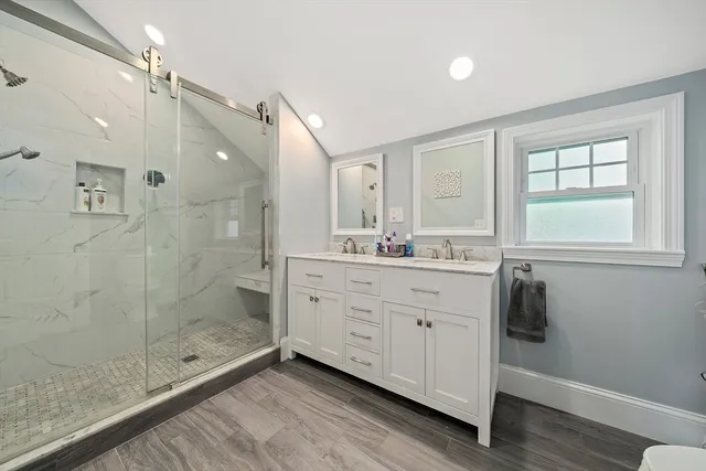 a bathroom with a shower sink and mirror