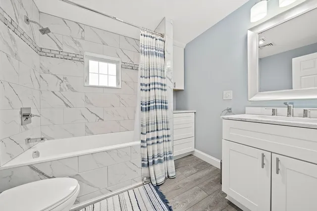 a bathroom with a sink toilet a shower and a mirror