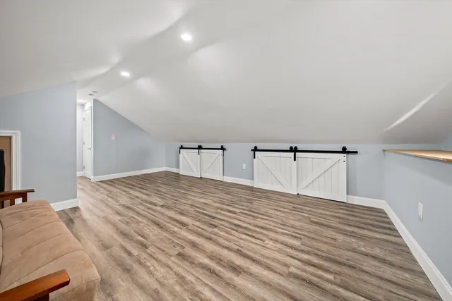 a bedroom with a bed and painting on the wall