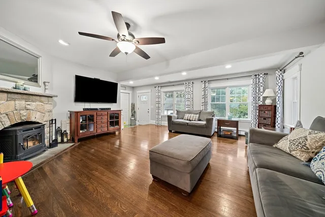 a living room with fireplace furniture and a flat screen tv