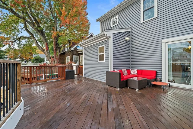 a view of deck with wooden floor and fence and a bench