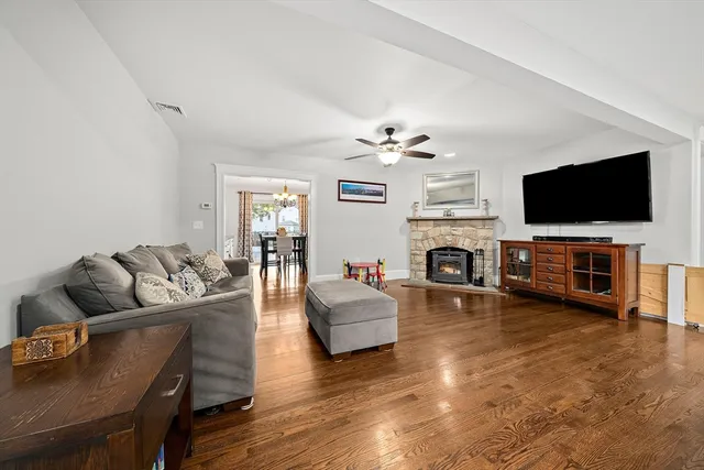 a living room with fireplace furniture and a flat screen tv
