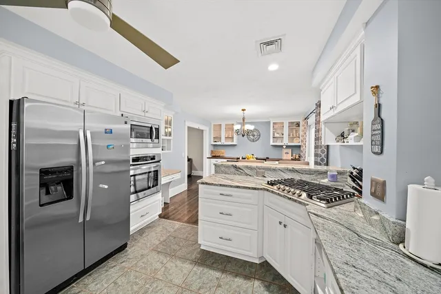 a kitchen with stainless steel appliances a refrigerator stove and sink