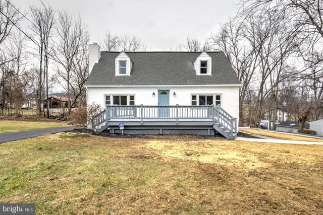 a view of a house with snow on the side of the road