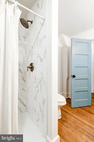 a bathroom with a shower and a sink