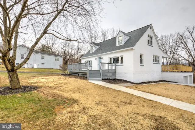 a view of a house with wooden fence