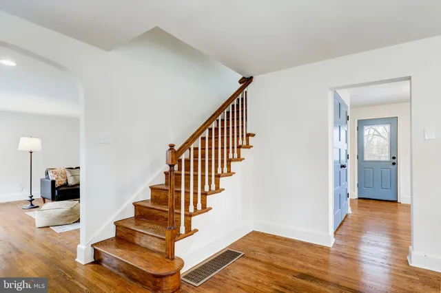 a view of entryway and hall with wooden floor