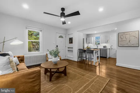 a living room with furniture and a view of kitchen